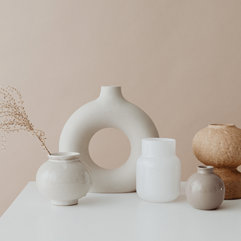 a collection of vases and pots on a table